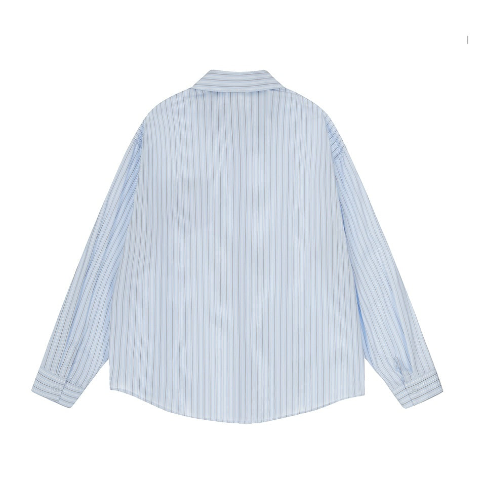Back view of a pale blue shirt with fine vertical stripes, long sleeves, and button cuffs.
