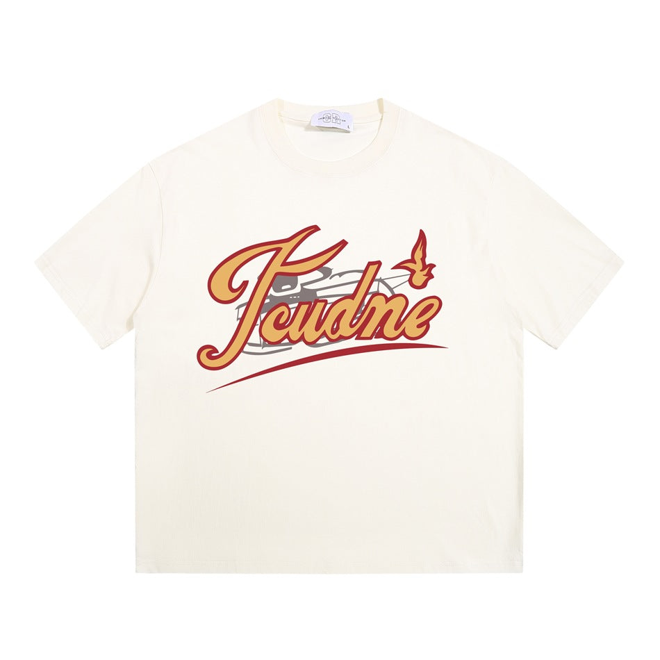 Cream apricot crew neck T-shirt flat lay with yellow and red retro script graphic on the chest