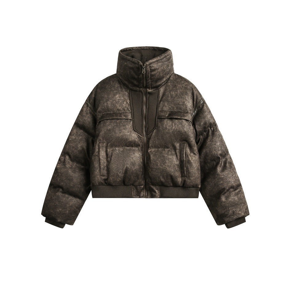 Cropped brown mottled quilted puffer jacket with stand collar, front zipper, ribbed hem and cuffs on a white background
