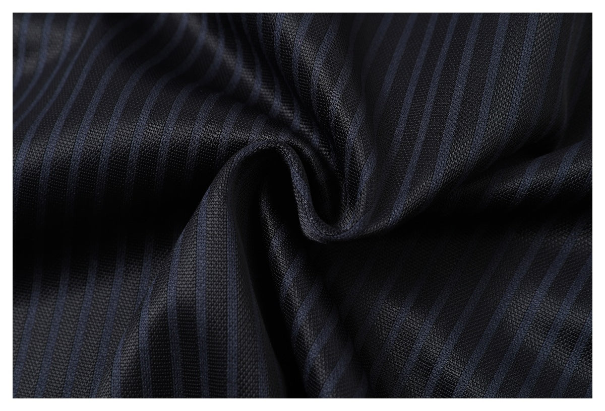 Macro view of gathered dark jersey fabric with subtle blue pinstripes and a textured surface.