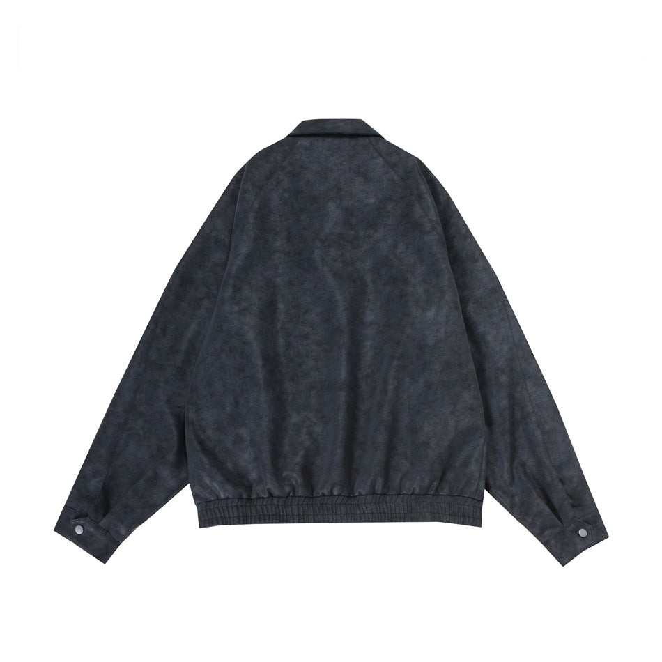 Back flat lay of a charcoal jacket with raglan sleeves, buttoned cuffs, and an elasticated hem.