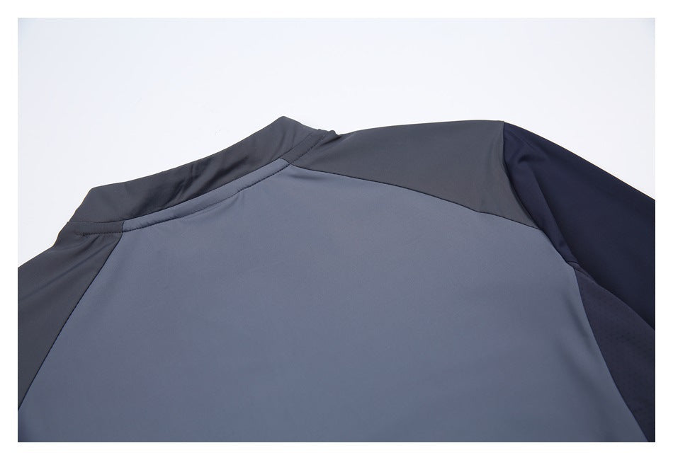 Upper back of a slate-gray athletic top with dark shoulder and sleeve panels.