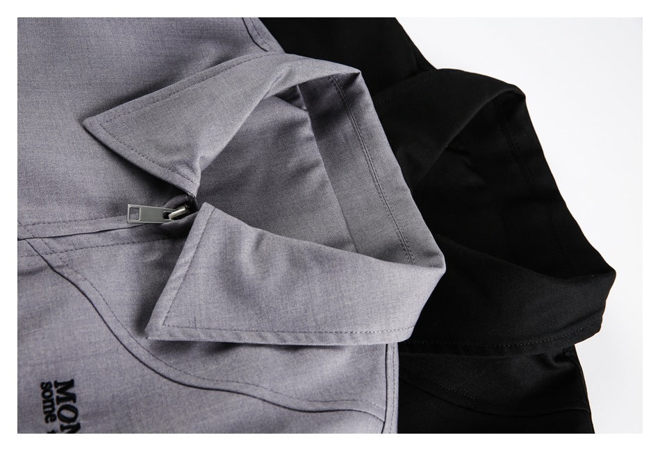 Close-up of overlapping gray and black jacket collars with a zipper on the gray jacket.