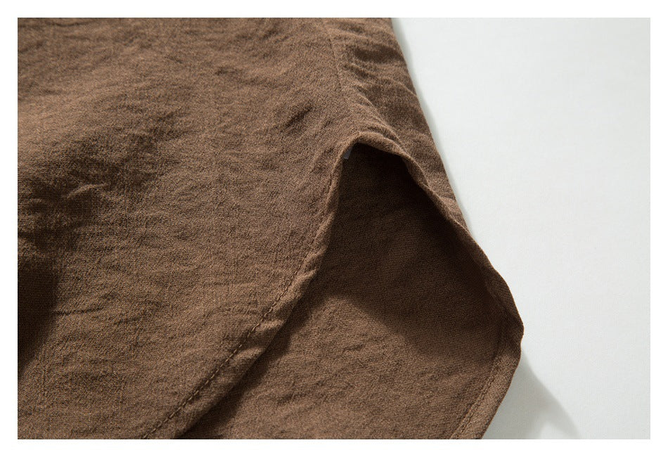 Close-up of a curved opening and stitched edge in brown garment fabric.