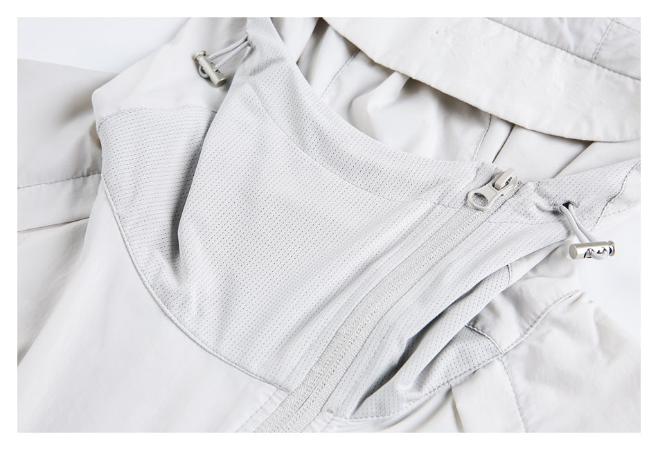 Close-up of a white jacket with a perforated mesh front panel, zipper, and drawcord toggles.