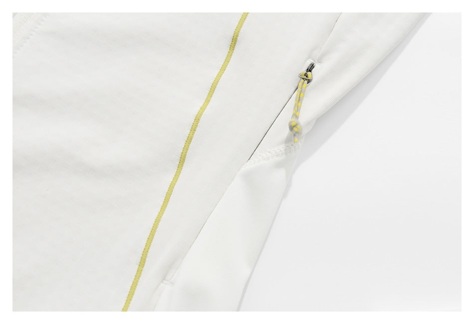 Close-up of a white jacket pocket zipper with a yellow-and-gray cord pull and yellow piping.