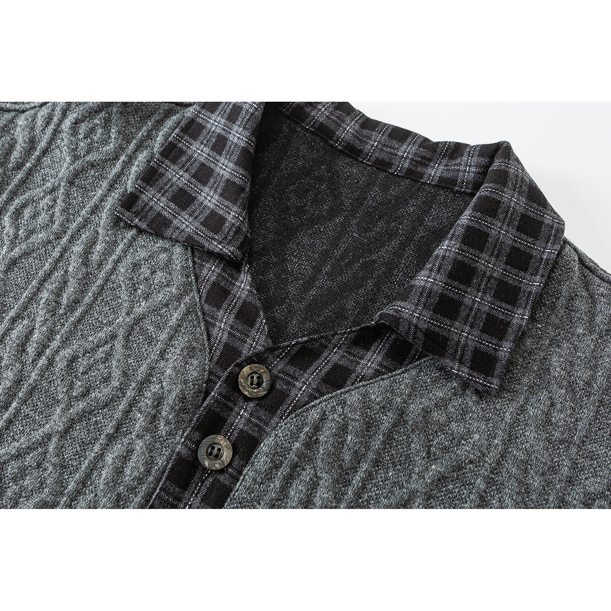 Close-up of a charcoal gray shirt collar and button placket with black plaid trim and two buttons.