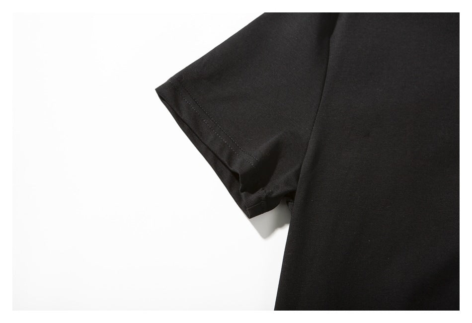 Close-up of a short sleeve and stitched hem on a plain black T-shirt.