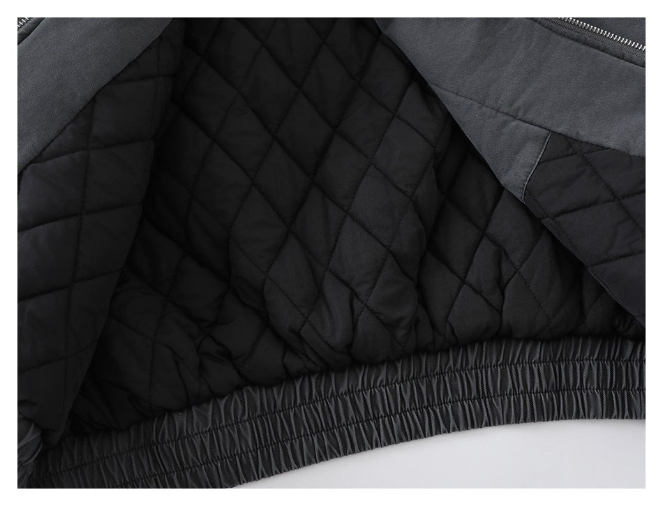Close-up of the jacket's black diamond-quilted lining and gathered elastic hem.