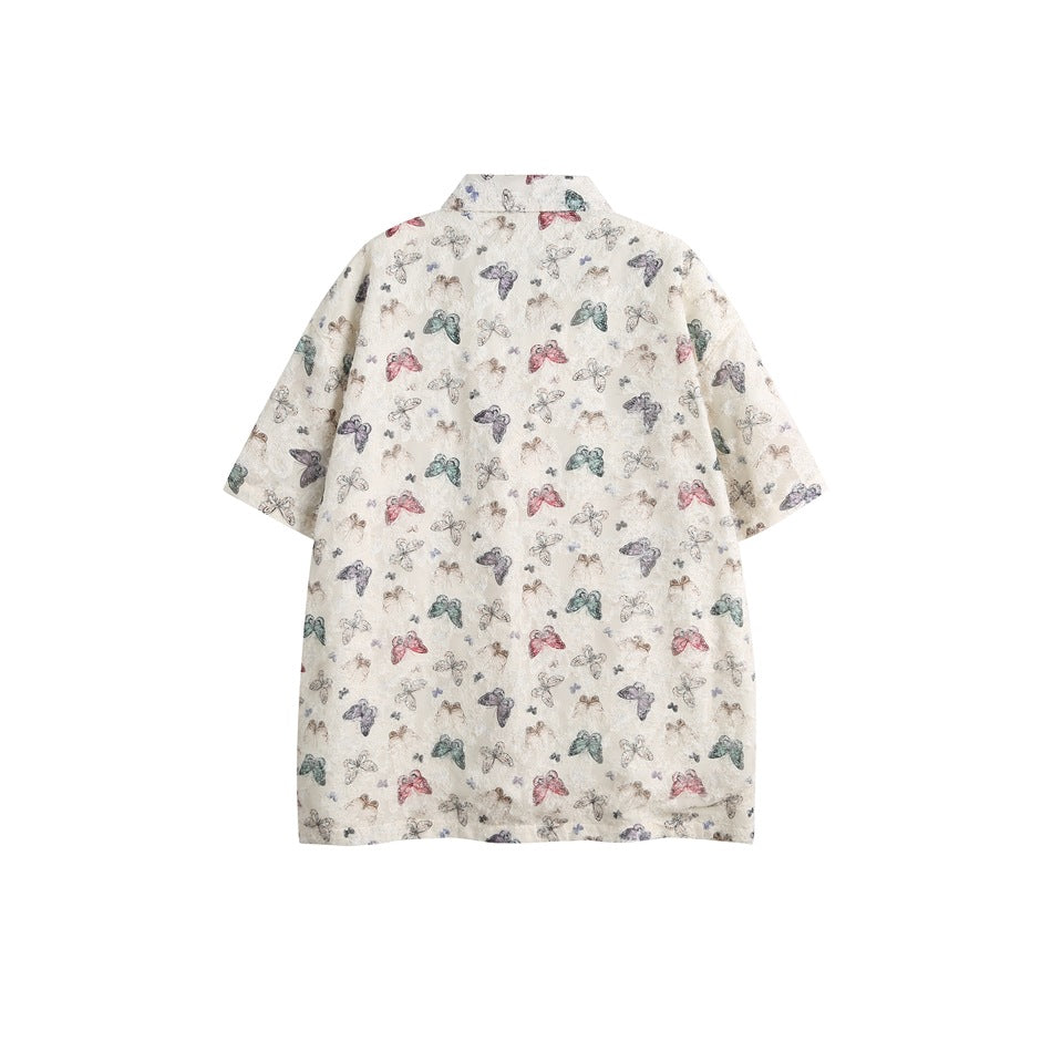 Back view of an off-white short-sleeve button-up shirt with a multicolored butterfly print.