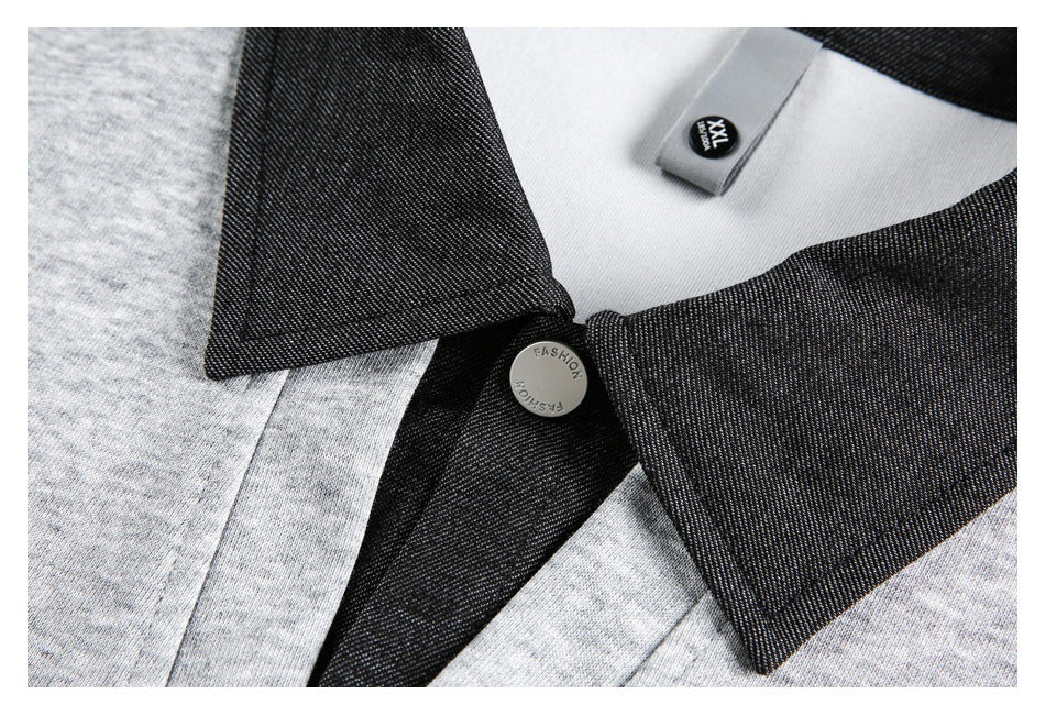 Close-up of a pullover's dark collar and button, with a visible XXL size label.