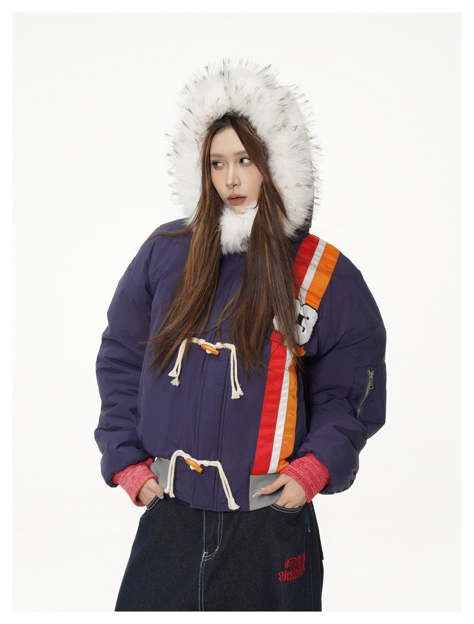 Model wearing a navy jacket with a white fur-trimmed hood, rope toggles, red cuffs and orange-red stripes.