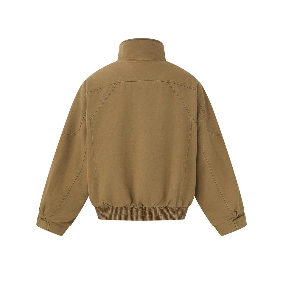 Back view of a tan jacket with a stand collar, curved shoulder seams and a gathered elastic hem.