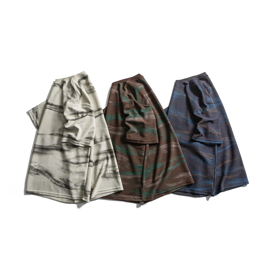 Three short-sleeve shirts in ivory-gray, brown-green, and navy-blue mottled stripe patterns, arranged together.