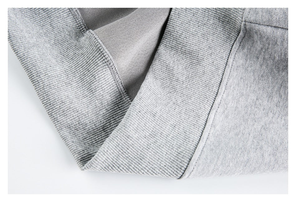Close-up of the gray hoodie’s ribbed cuff and inner fabric at the sleeve opening.