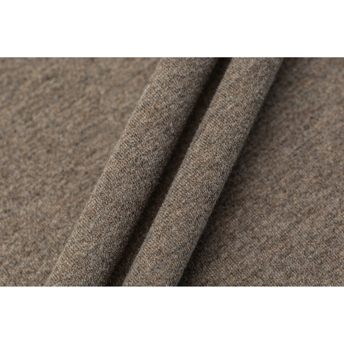Close-up of taupe-brown heathered fabric folded into soft ridges.