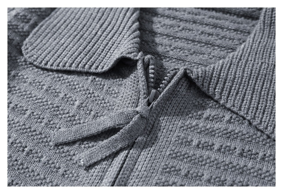 Close-up of the gray cardigan's zipper, pull tab, wide ribbed collar, and textured knit.