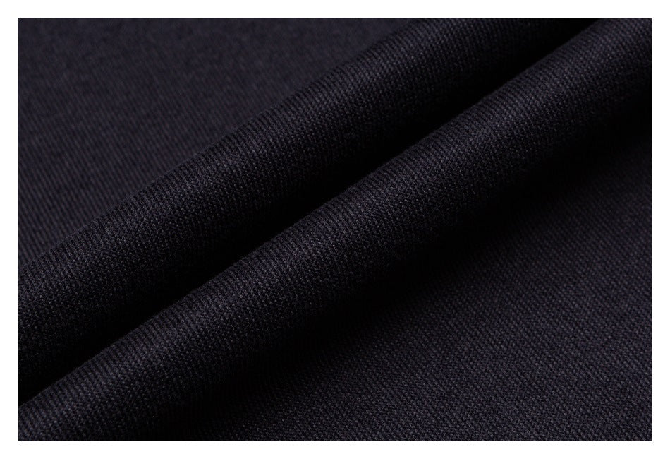 Close-up of dark fabric folded to show its textured surface.