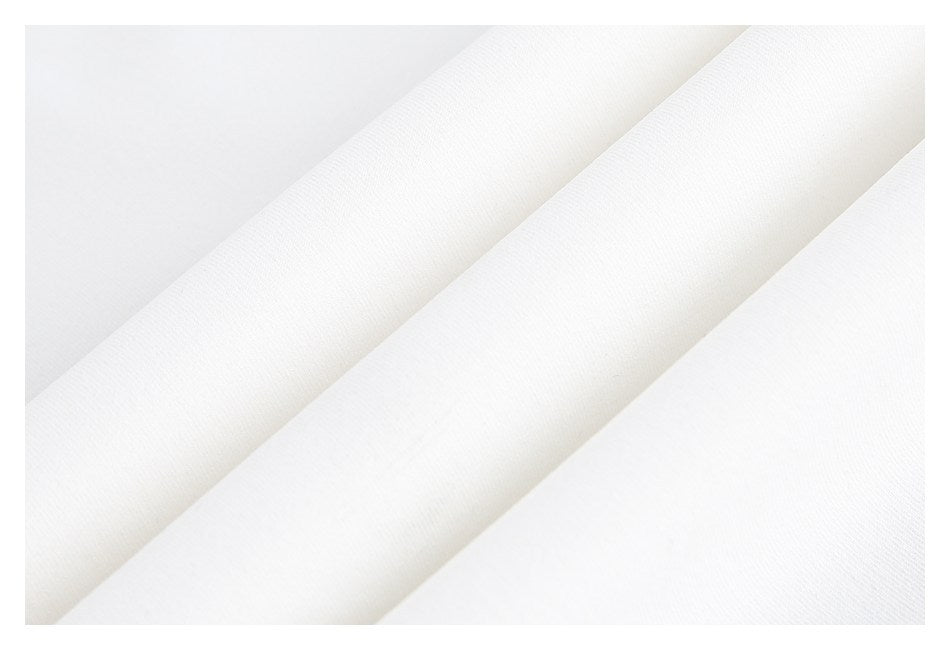 Close-up of white garment fabric arranged in soft diagonal folds.