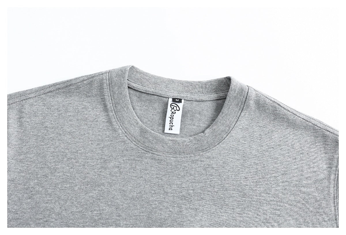 Close-up of the heather gray T-shirt's ribbed crew neck and inner label.