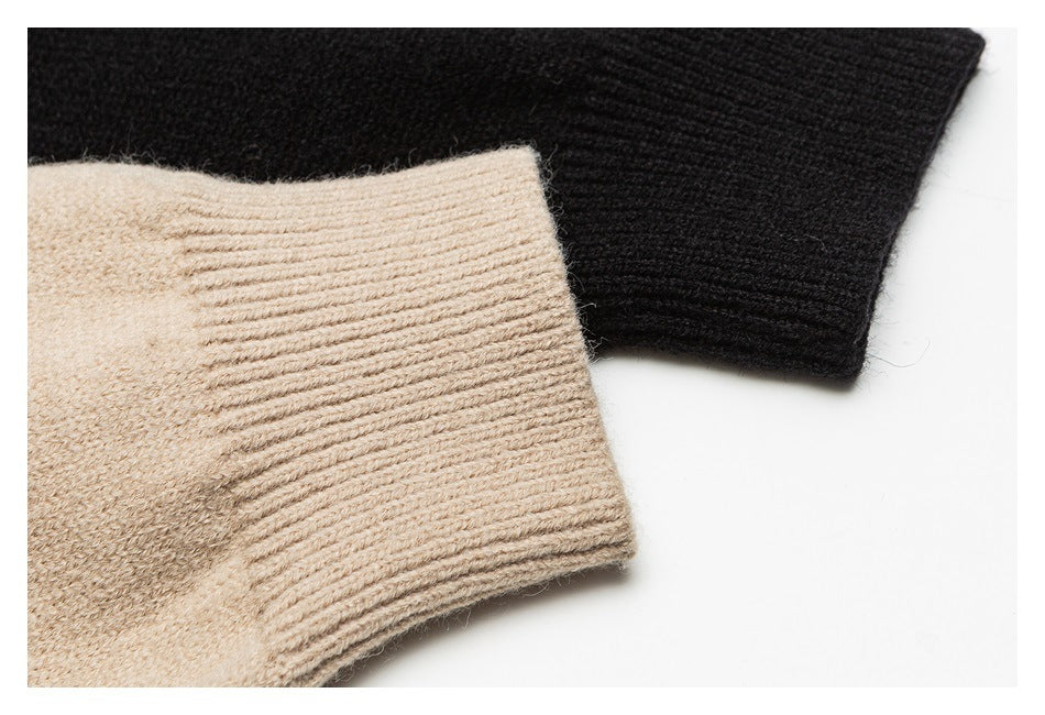 Close-up of ribbed beige and black sweater cuffs showing the knit texture.