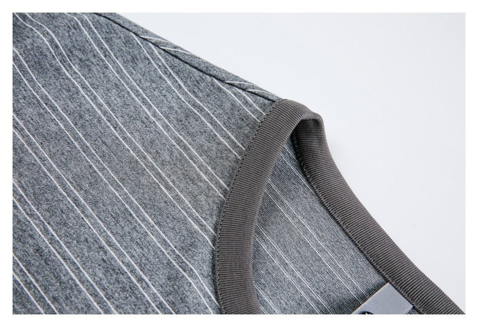 Close-up of the gray striped knit top's ribbed neckline and shoulder seam.