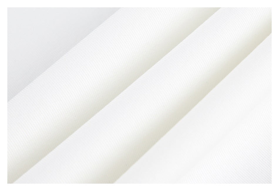 Close-up of white fabric arranged in soft folds, showing a fine textured surface.