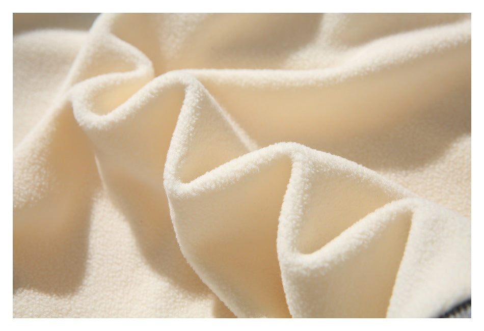 Close-up showing the soft, textured cream fabric draped in folds.