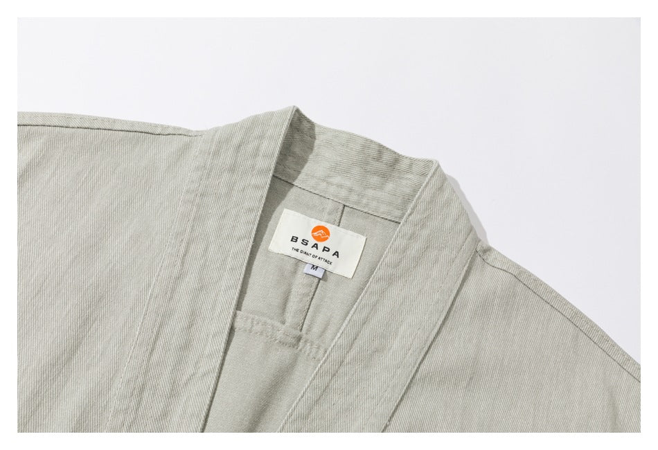 Close-up of the collar and inner neck label on a light gray-green jacket.