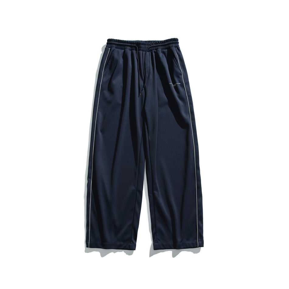 Navy wide-leg drawstring pants with light side piping, flat lay front view