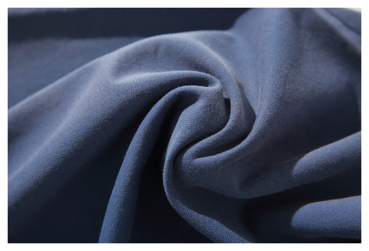 Close-up of soft-looking blue fabric gathered into folds.