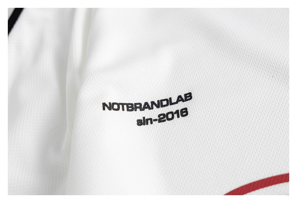 Close-up of small black lettering printed on white textured jersey fabric.