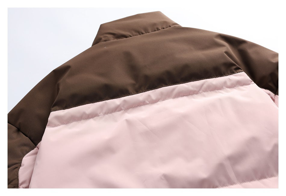 Close-up of a jacket's dark brown upper back panel above a dusty pink padded section.