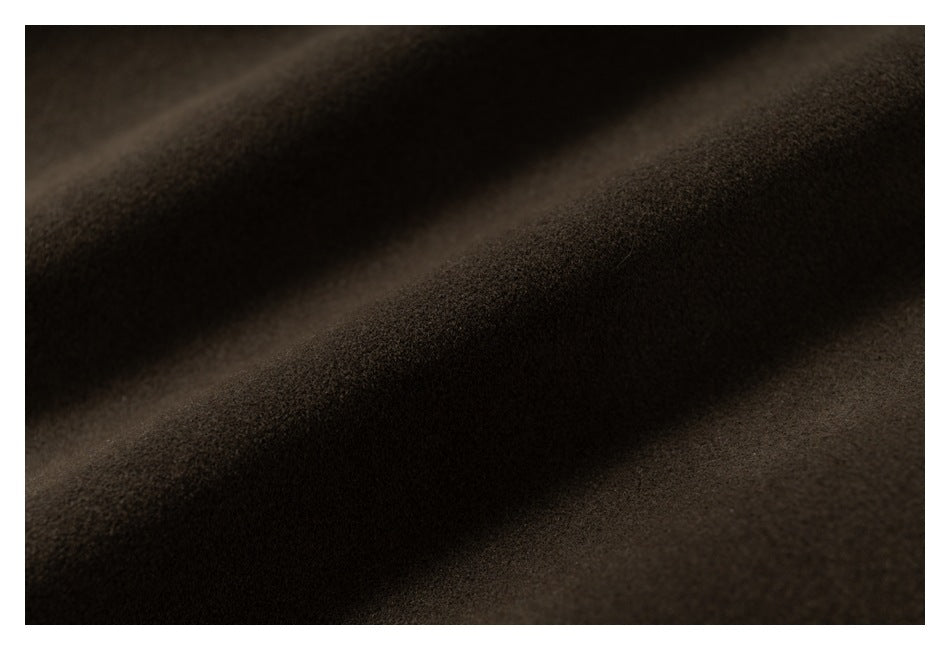 Close-up of dark brown, fuzzy fabric with soft diagonal folds.