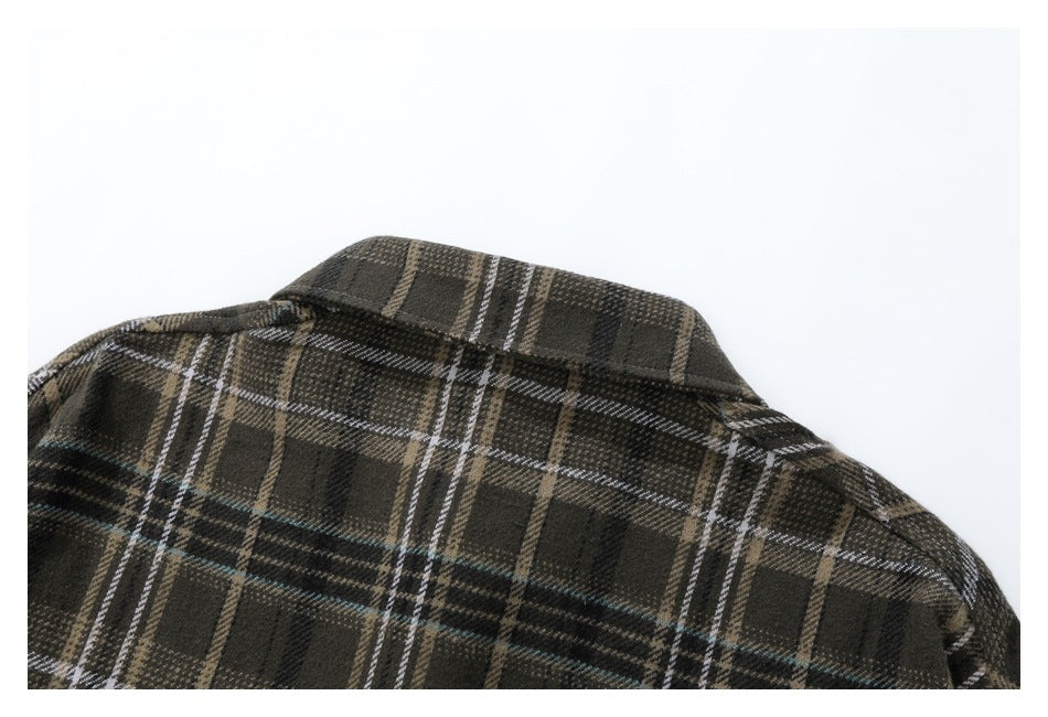 Close-up of the back collar and shoulder area of a dark brown plaid shirt.