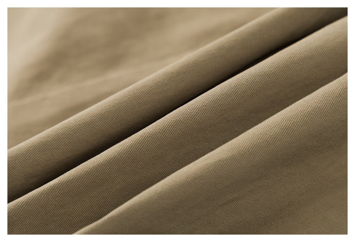 Extreme close-up of the khaki fabric, showing its diagonal woven texture.