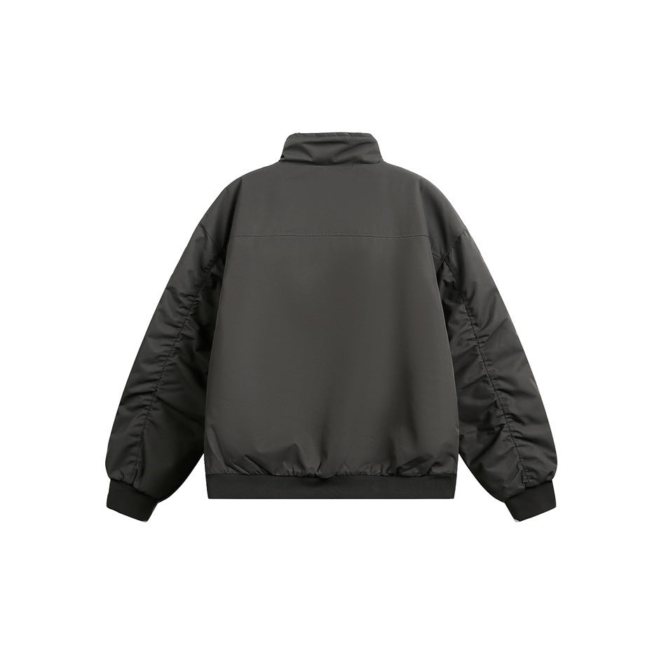 Back view of a charcoal gray jacket with a stand collar, gathered sleeves, and ribbed cuffs and hem.