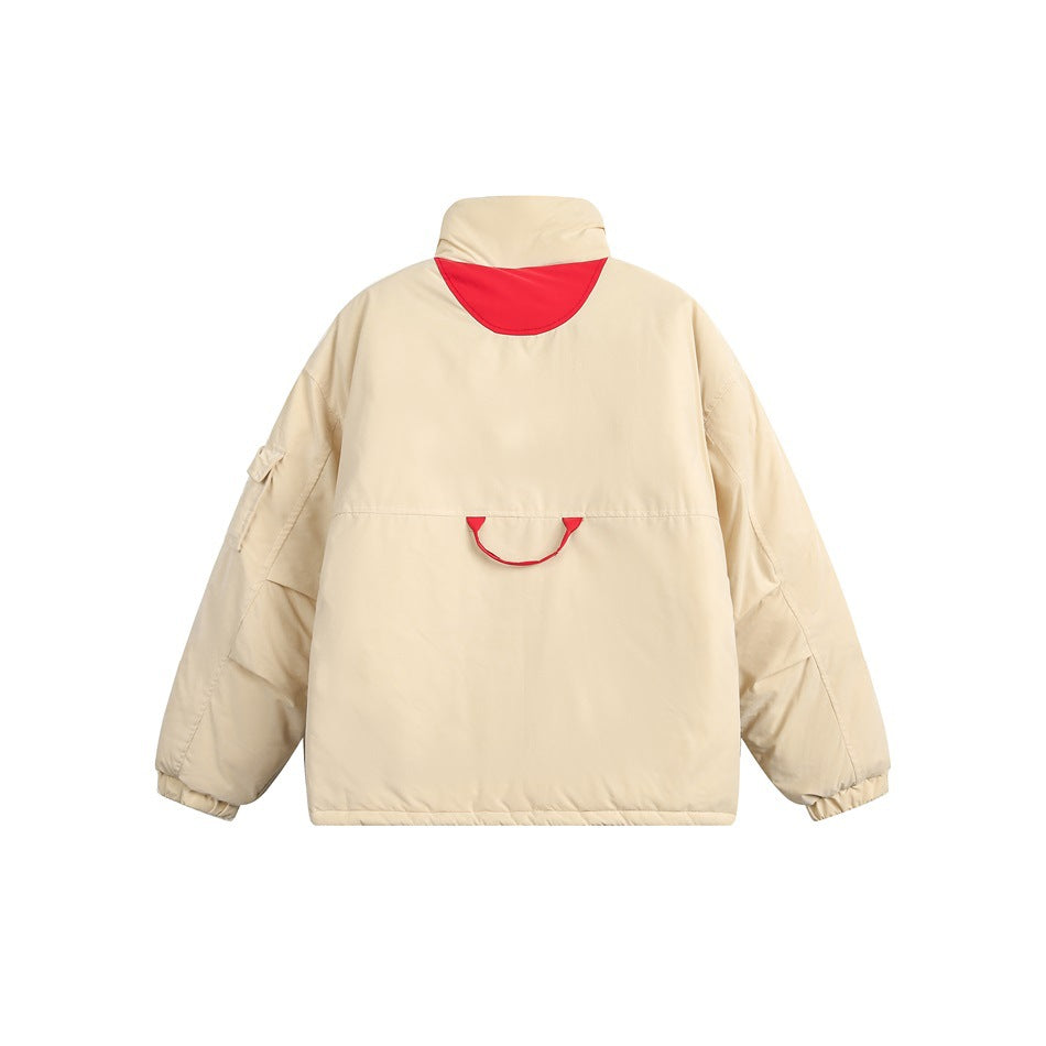 Back view of a cream jacket with a red shoulder insert, a red loop detail, and gathered cuffs.