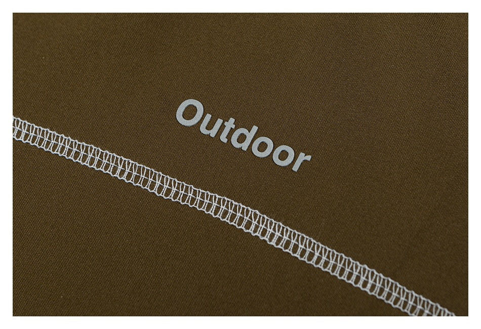 Close-up of olive fabric showing white “Outdoor” lettering above a diagonal white overlock seam.
