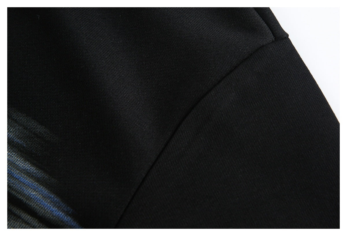 Close-up of black garment fabric meeting along a curved seam.