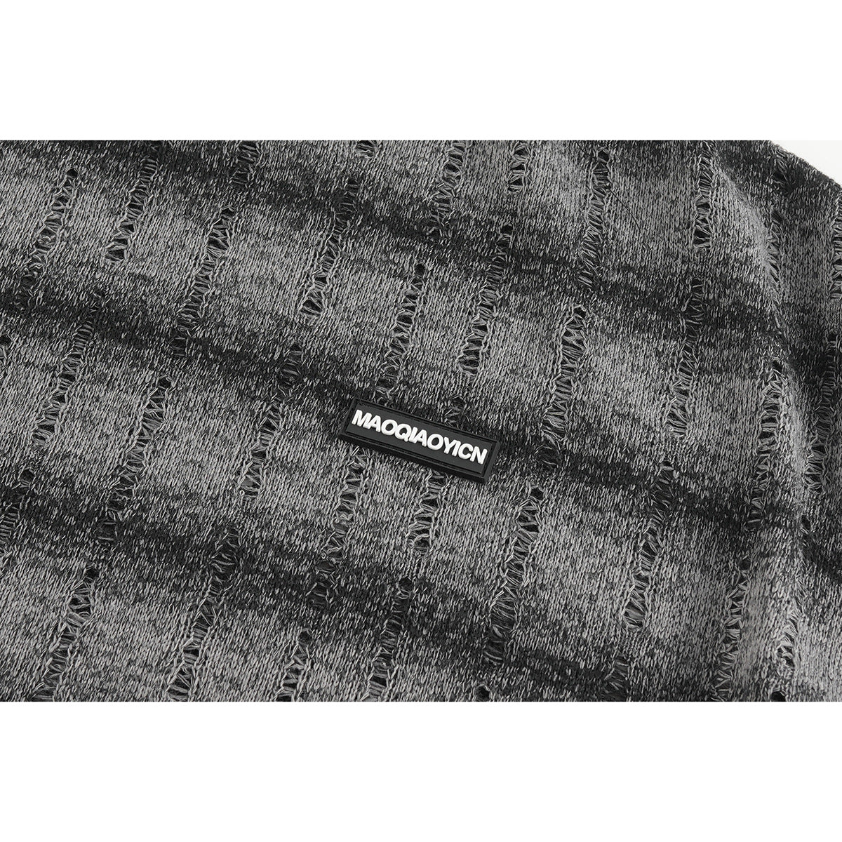 Close-up of the shirt’s gray-and-black textured pattern and small rectangular chest patch.