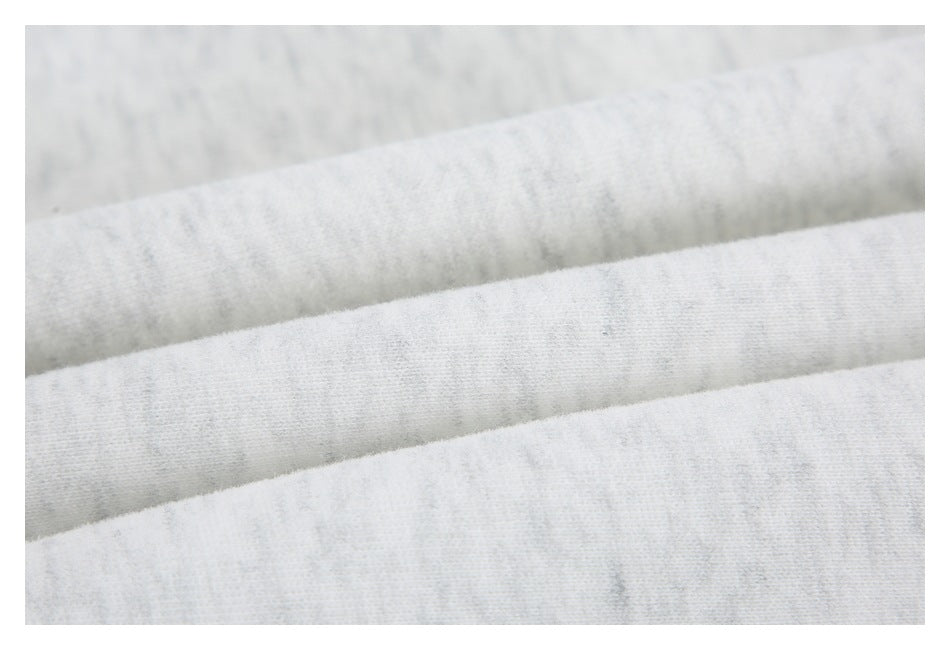 Close-up showing the light gray marled fabric folded into soft parallel ridges.