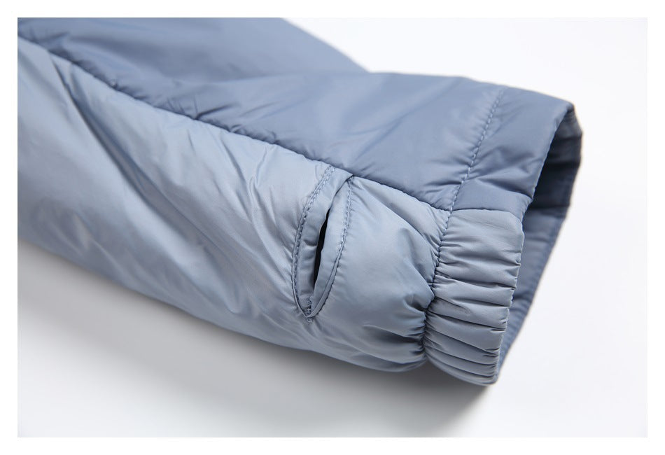 Close-up of a blue padded jacket sleeve with a narrow opening and gathered elastic cuff.