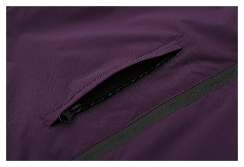 Close-up of a diagonal black zipper pocket on purple fabric.