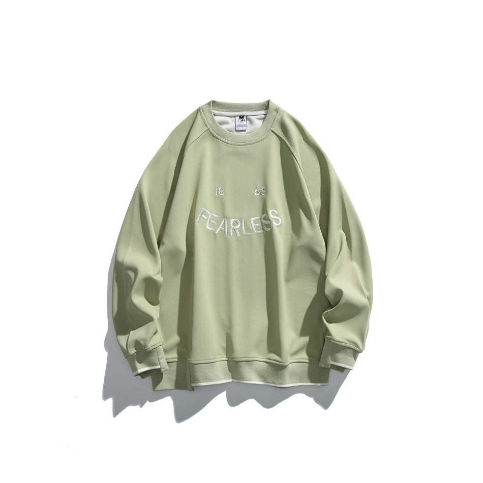 Light green crew-neck sweatshirt with tonal FEARLESS 18 63 chest embroidery and cream stripe trim at the cuffs and hem