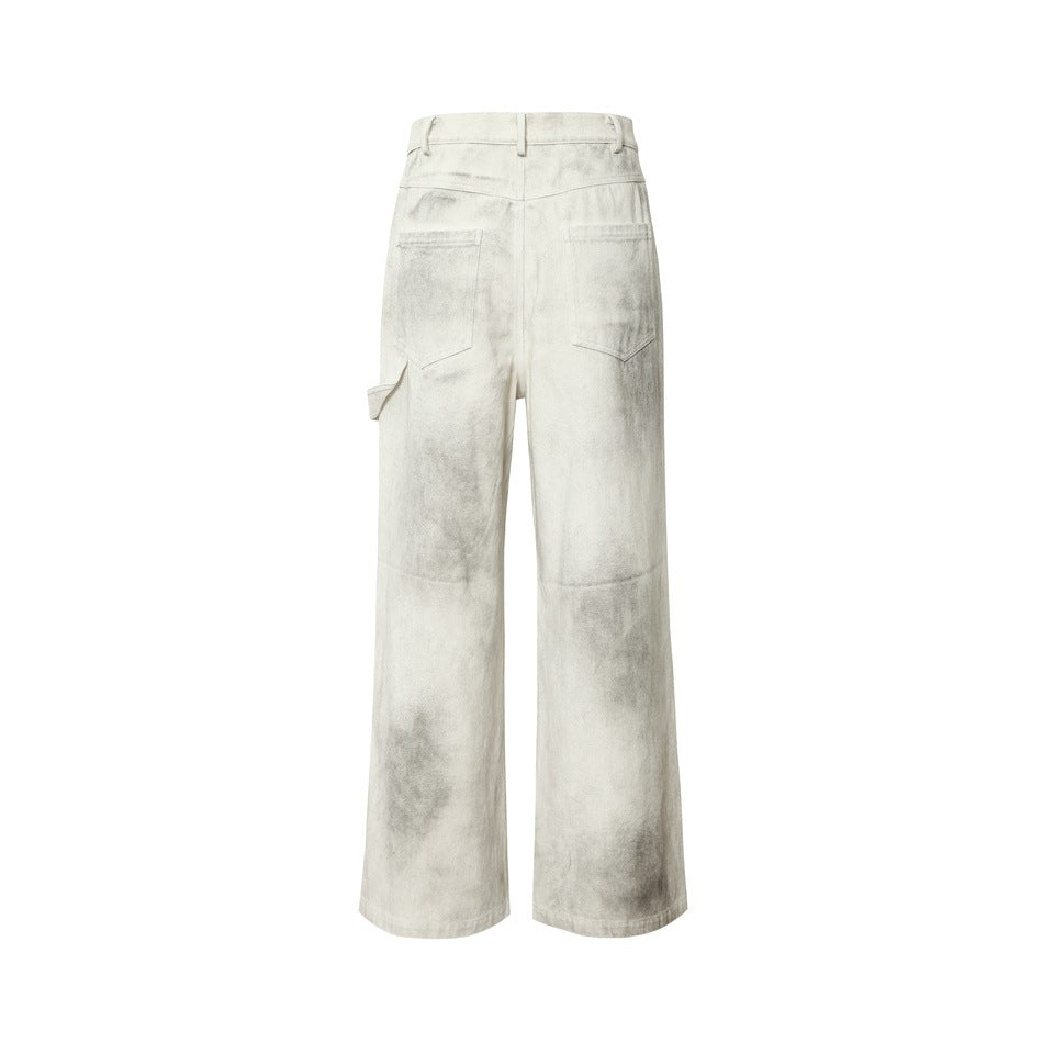Isolated rear view of off-white wide-leg trousers with gray distressed marks, belt loops, and two back pockets.