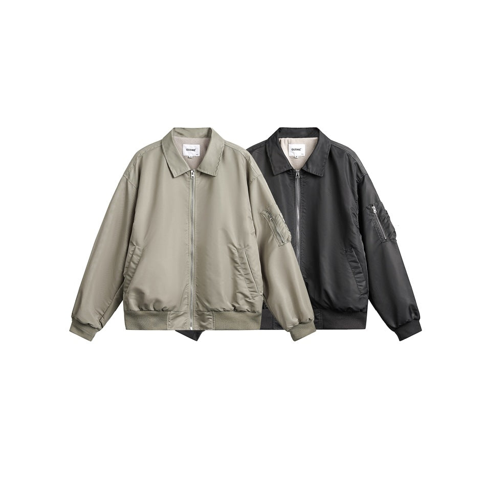 Two zip-front jackets shown together: one muted gray-green and one charcoal, both with collars and sleeve pockets.