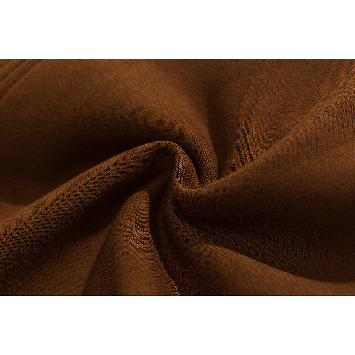 Macro view of rust-brown jacket fabric gathered into soft folds.