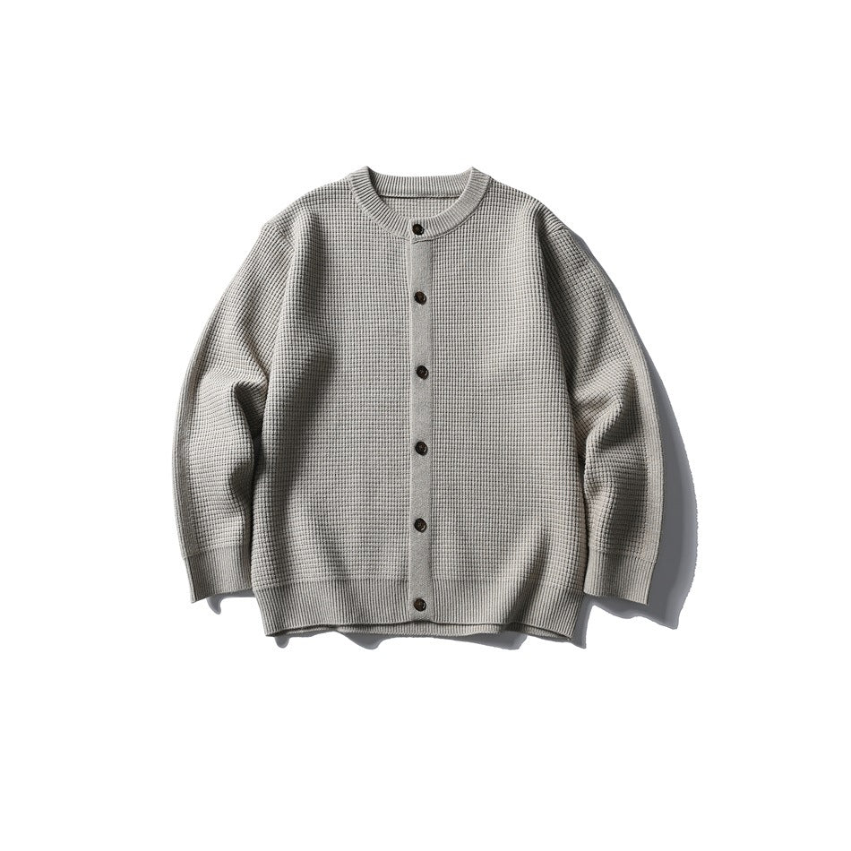 Khaki waffle-knit button-front cardigan with round neckline and ribbed cuffs and hem, laid flat