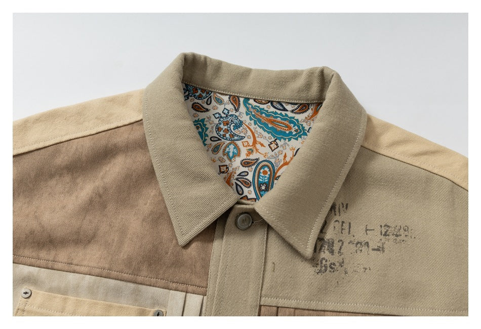 Close-up of the jacket's pointed collar, button placket, paisley-patterned lining and distressed-style marks.